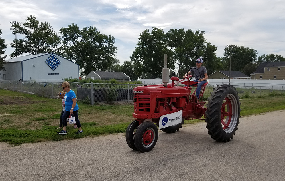 The Day's Farmall tractor being driven in the celebrati
